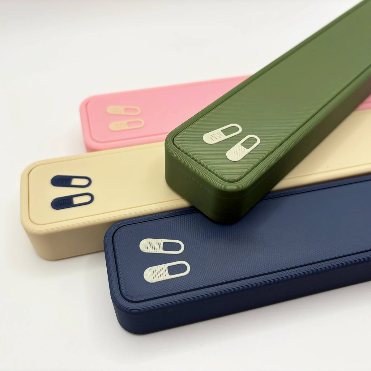 Glidra weekly pill cases in navy, olive, beige and pink